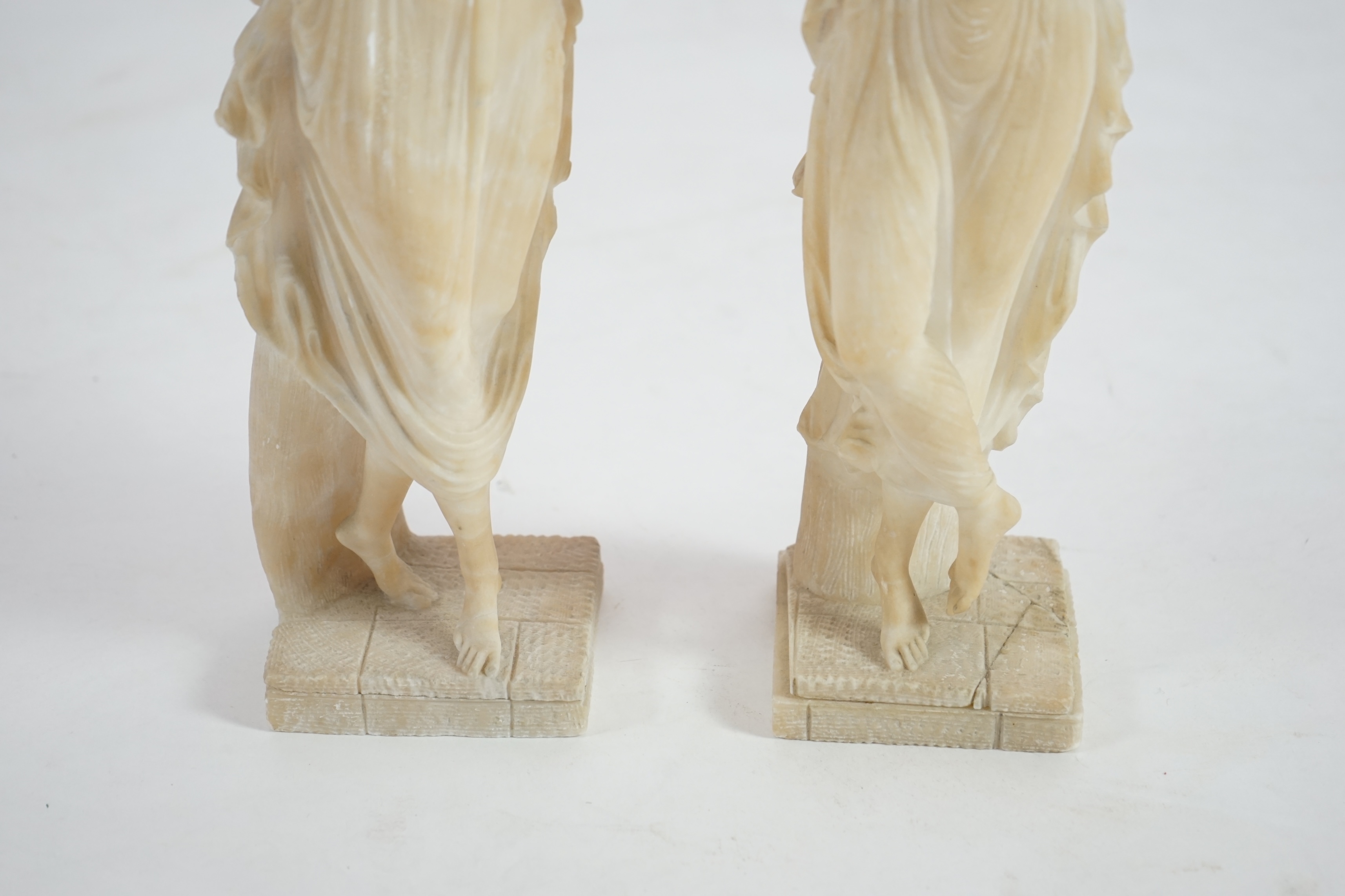 After the antique, a pair of 19th century Italian carved alabaster figures of muses